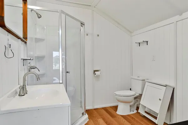 a bathroom with a sink toilet and shower