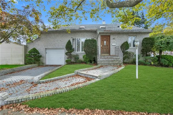 a front view of a house with garden