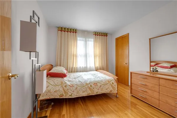 a bedroom with a bed and a dresser