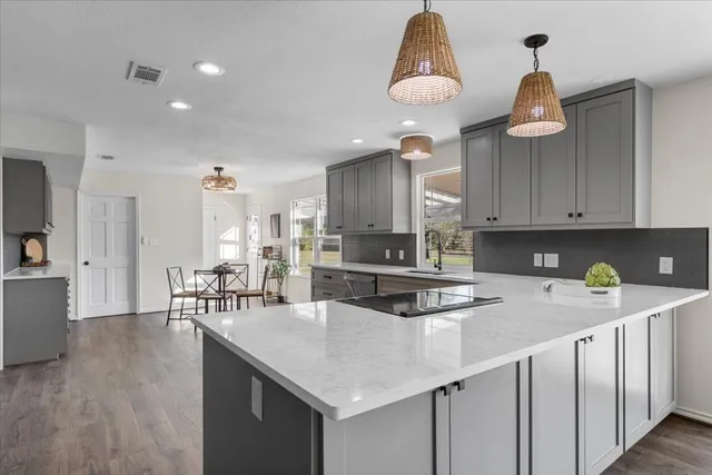 a kitchen with a sink cabinets and window