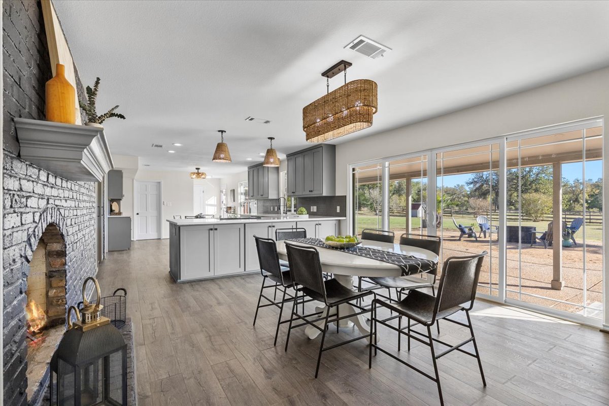 1180 Live Oak Loop Buda, TX 78610 - Photo 12 of 39 Dining room with a real wood burning fireplace!
