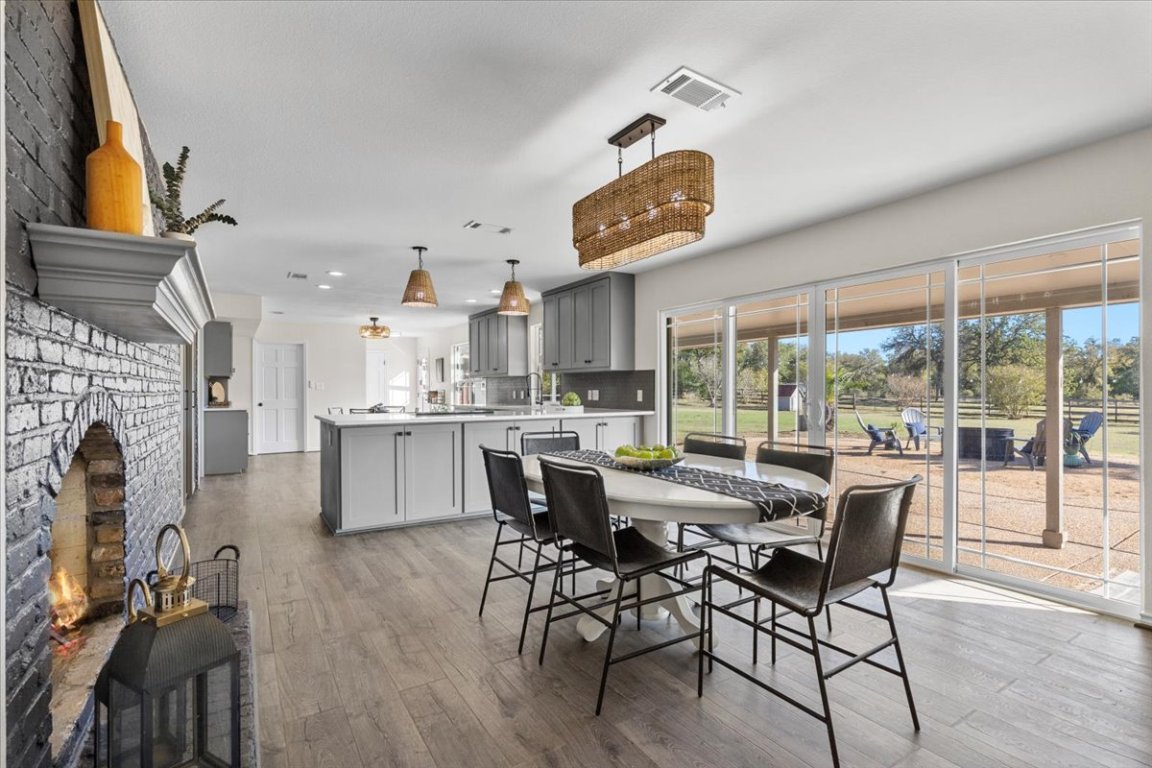 1180 Live Oak Loop Buda, TX 78610 - Photo 12 of 39 Dining room with a real wood burning fireplace!