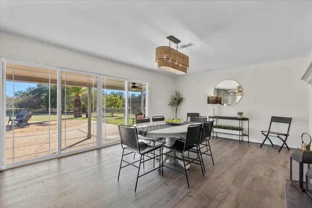 a view of a dining room with furniture wooden floor and chandelier