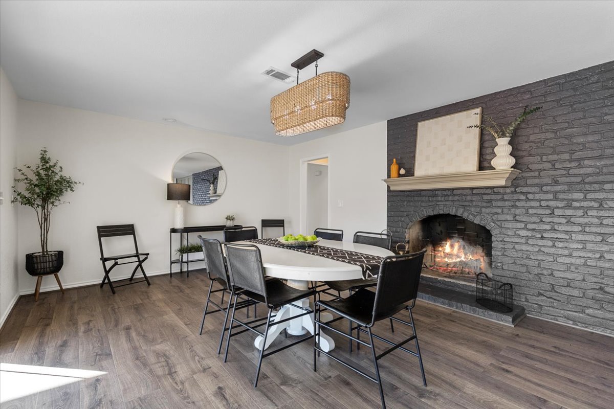 1180 Live Oak Loop Buda, TX 78610 - Photo 14 of 39 A dramatic brick fireplace will make this a great place for dinner parties, family gatherings, or projects that need to get done!