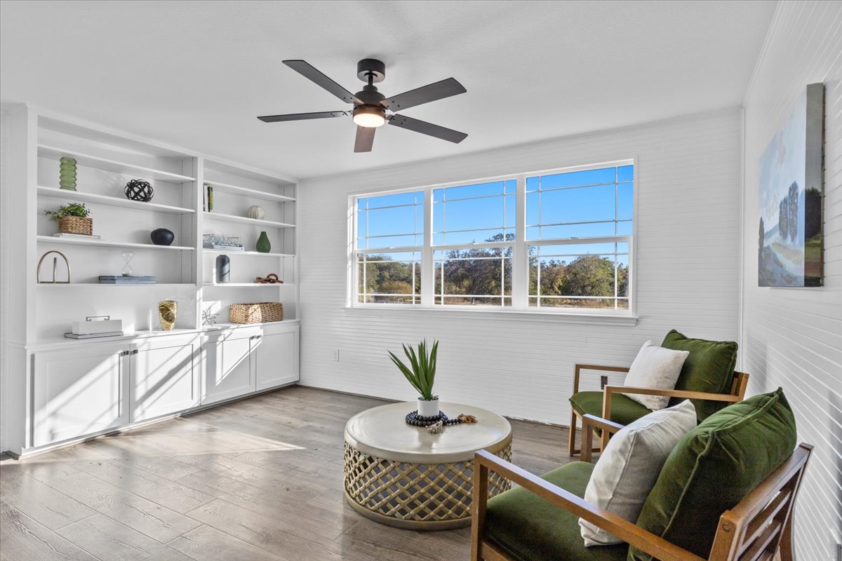 1180 Live Oak Loop Buda, TX 78610 - Photo 19 of 39 Sitting room with built in bookcases located just off of the primary bedroom.