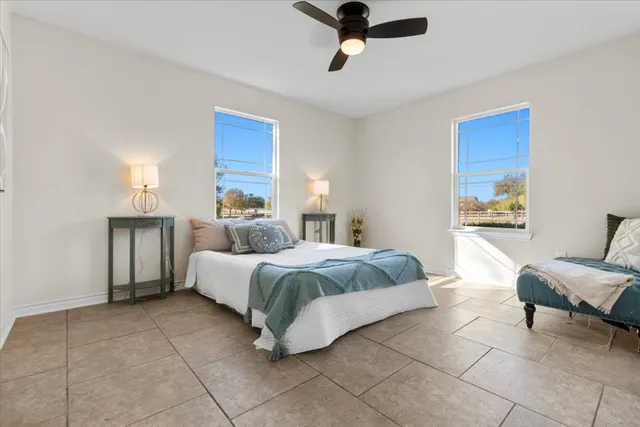 a spacious bedroom with a bed and furniture