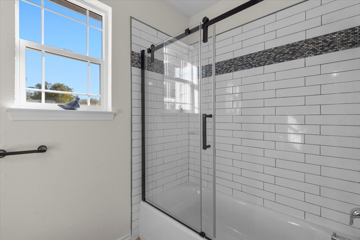 1180 Live Oak Loop Buda, TX 78610 - Photo 24 of 39 Bathroom featuring combined bath / shower with glass door