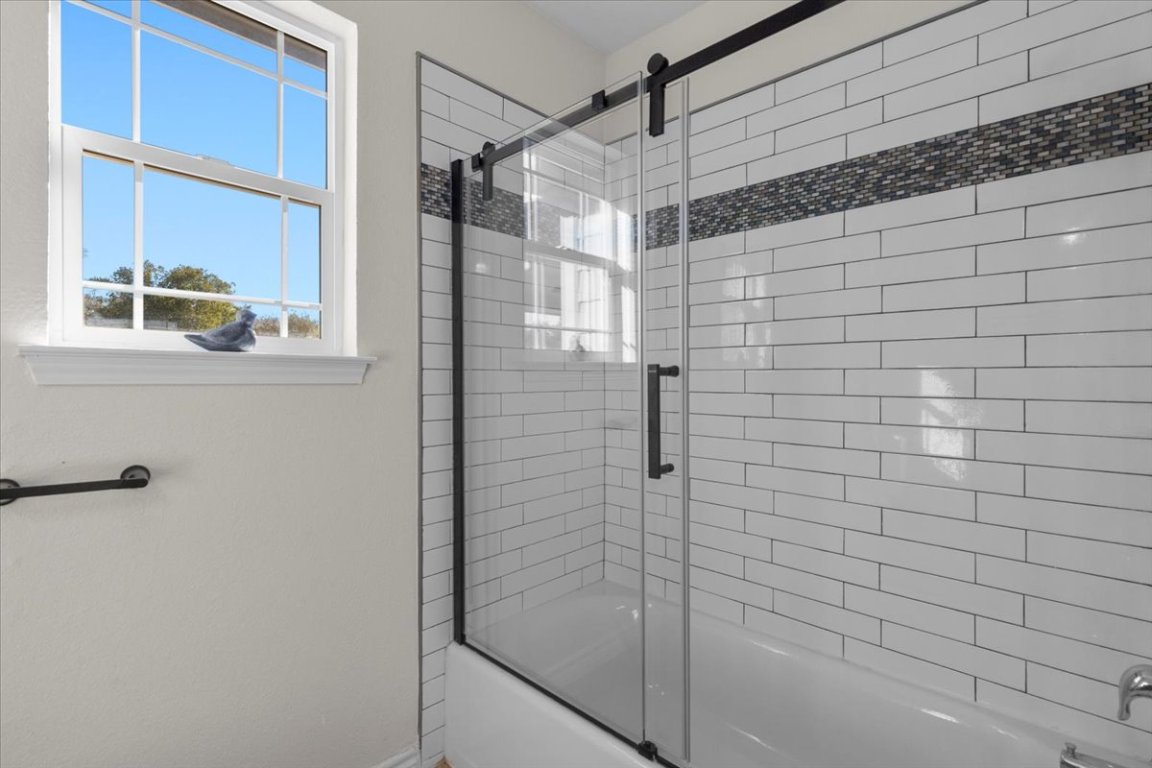 1180 Live Oak Loop Buda, TX 78610 - Photo 24 of 39 Bathroom featuring combined bath / shower with glass door