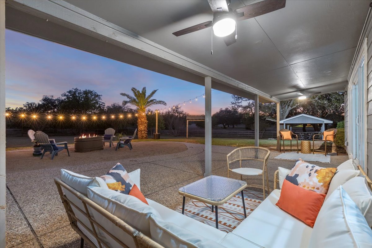 1180 Live Oak Loop Buda, TX 78610 - Photo 27 of 39 Enjoy your evenings under the covered patio. New remote controlled fans, lighting and an expansive yard give you endless nights of fun!