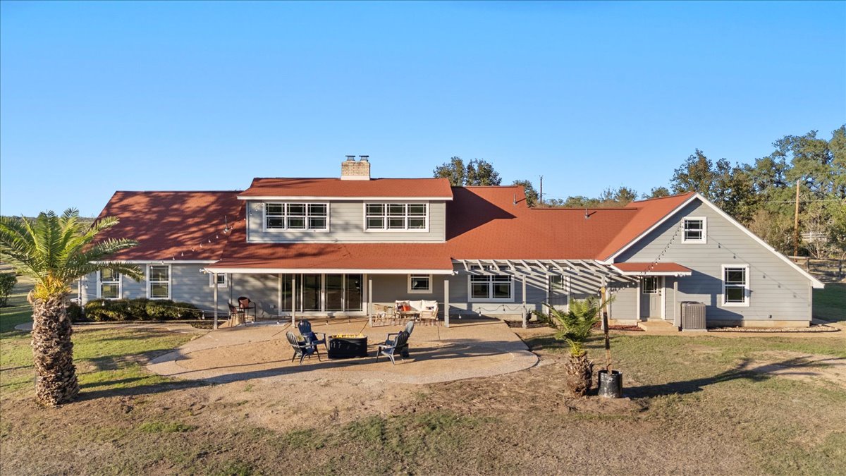1180 Live Oak Loop Buda, TX 78610 - Photo 29 of 39 Rear view of house featuring a patio,fire pit, and a pergola