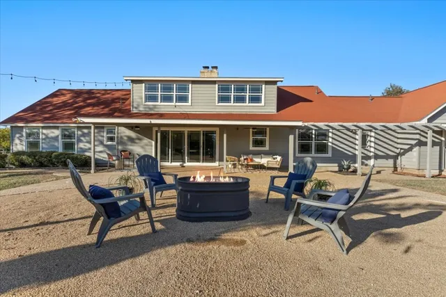 a backyard of a house with outdoor seating