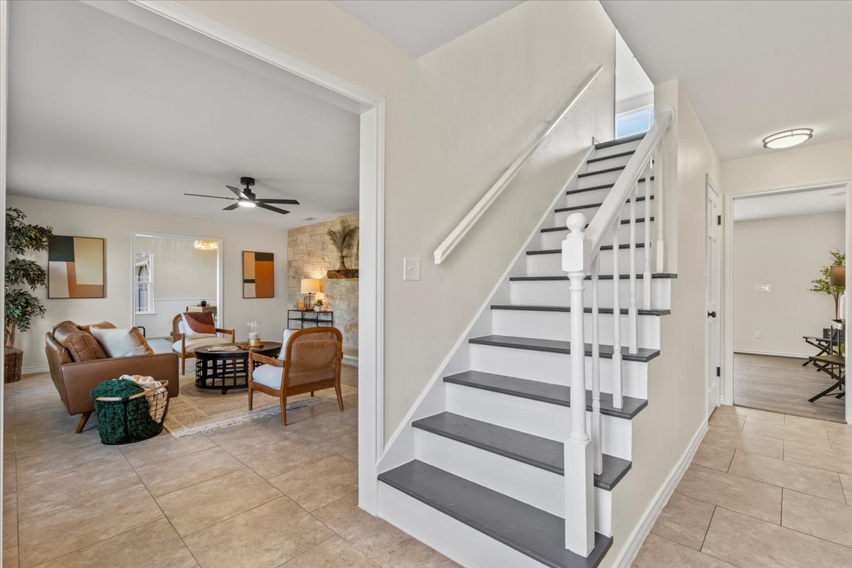 1180 Live Oak Loop Buda, TX 78610 - Photo 6 of 39 Staircase with tile patterned floors and a ceiling fan