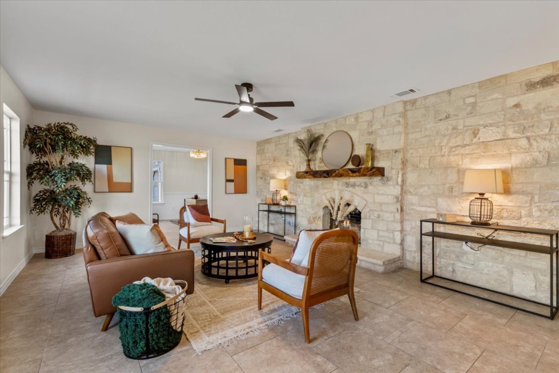1180 Live Oak Loop Buda, TX 78610 - Photo 7 of 39 An inviting family room welcomes you into the home. A true wood burning fire place designed around comfort and style give you a well appointed entry into a one-of-a kind home!
