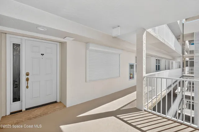 a kitchen with granite countertop a sink and white cabinets