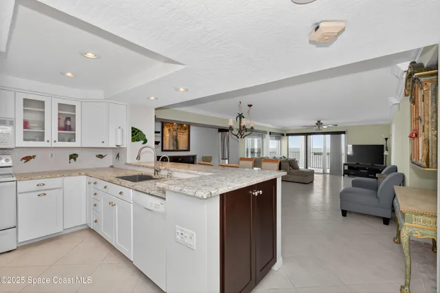 a dining room with furniture and a chandelier