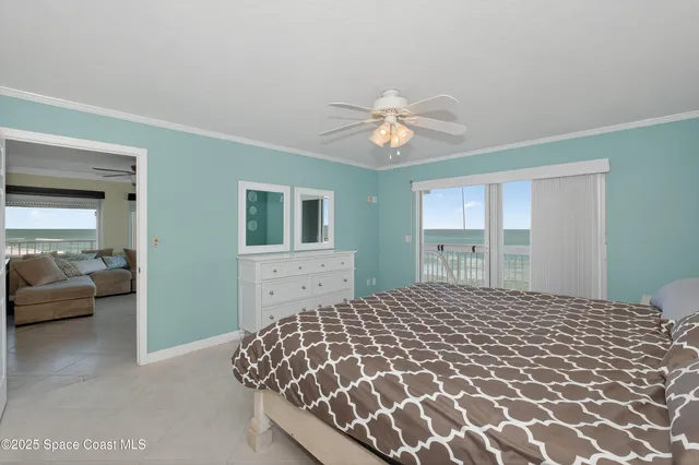 a bedroom with a bed and a lamp on the dresser