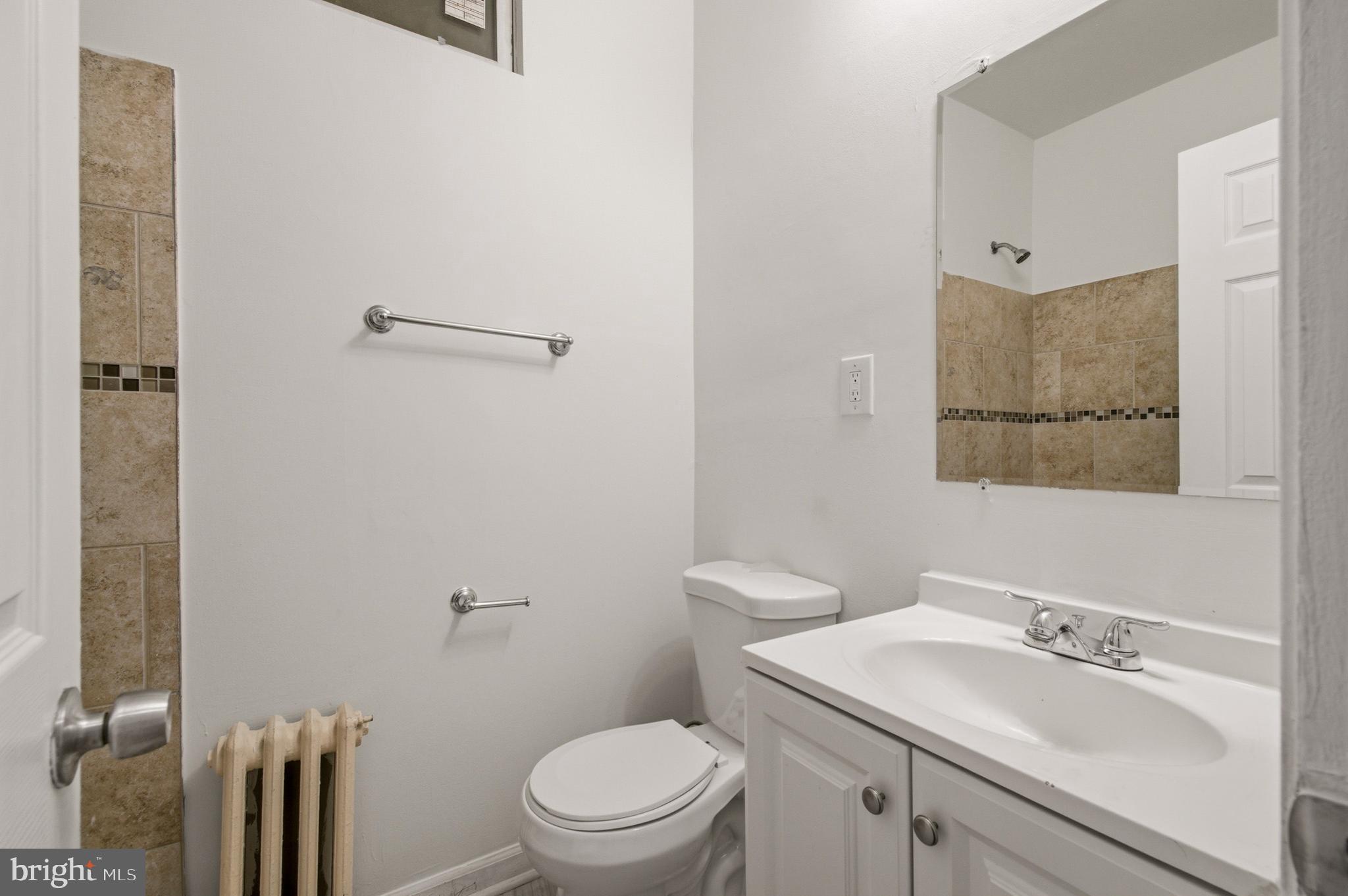 1616 Good Hope Road Southeast Washington, DC 20020 - Photo 17 of 25 a bathroom with a sink toilet and vanity