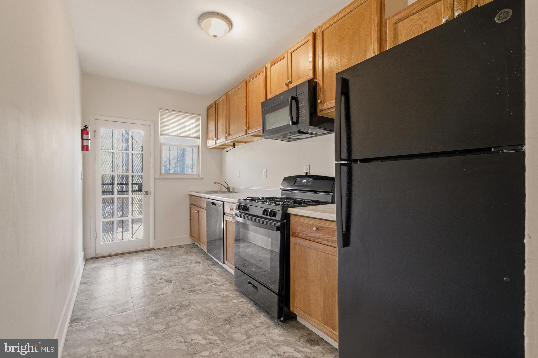 1616 Good Hope Road Southeast Washington, DC 20020 - Photo 2 of 25 a kitchen with stainless steel appliances granite countertop a refrigerator a stove a sink and a refrigerator