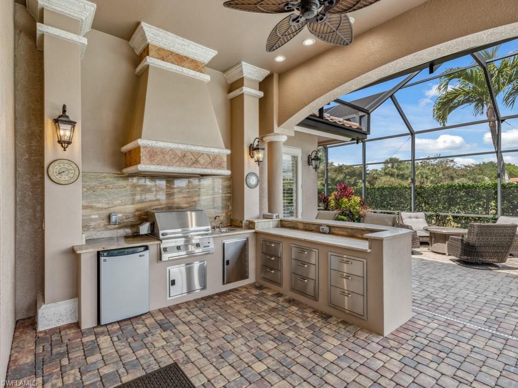 16509 Cellini Lane Naples, FL 34110 - Photo 5 of 49 a kitchen with stainless steel appliances granite countertop a sink and cabinets