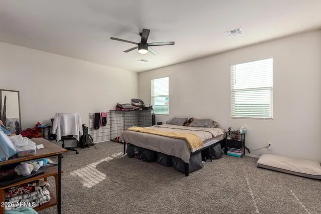 a bedroom with a bed a window and a couch