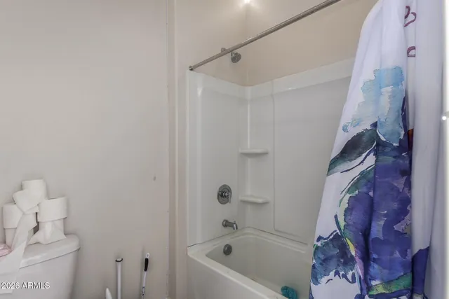 a living room with a baby bed furniture and a window