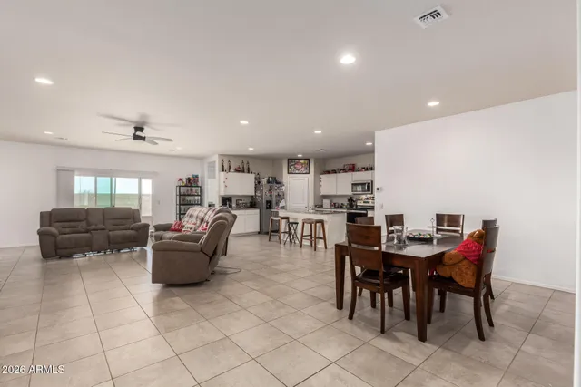 a living room with furniture kitchen view and a chandelier