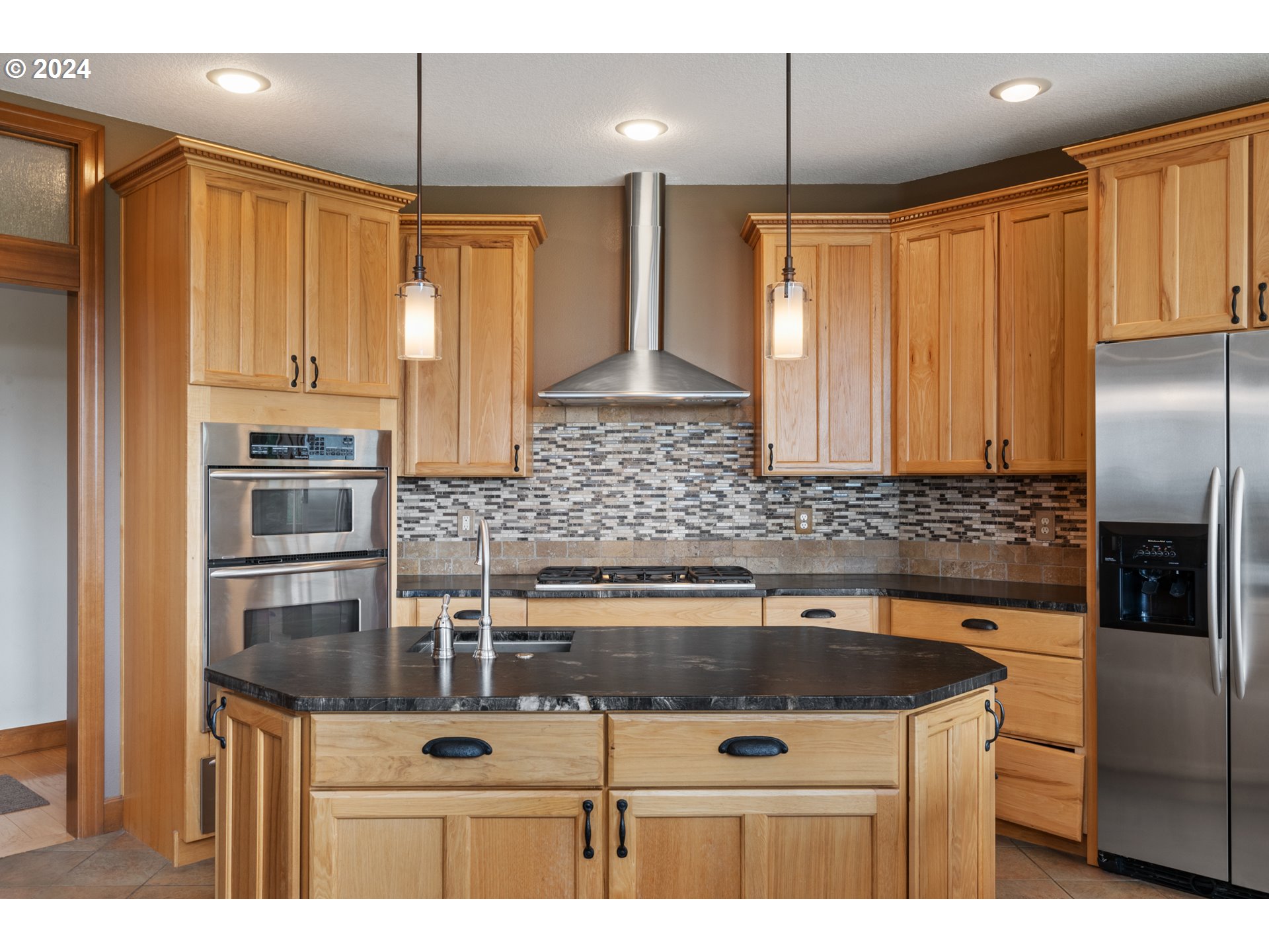 5924 Northeast Lessard Road Camas, WA 98607 - Photo 13 of 48 a kitchen with stainless steel appliances granite countertop a sink a stove and a refrigerator