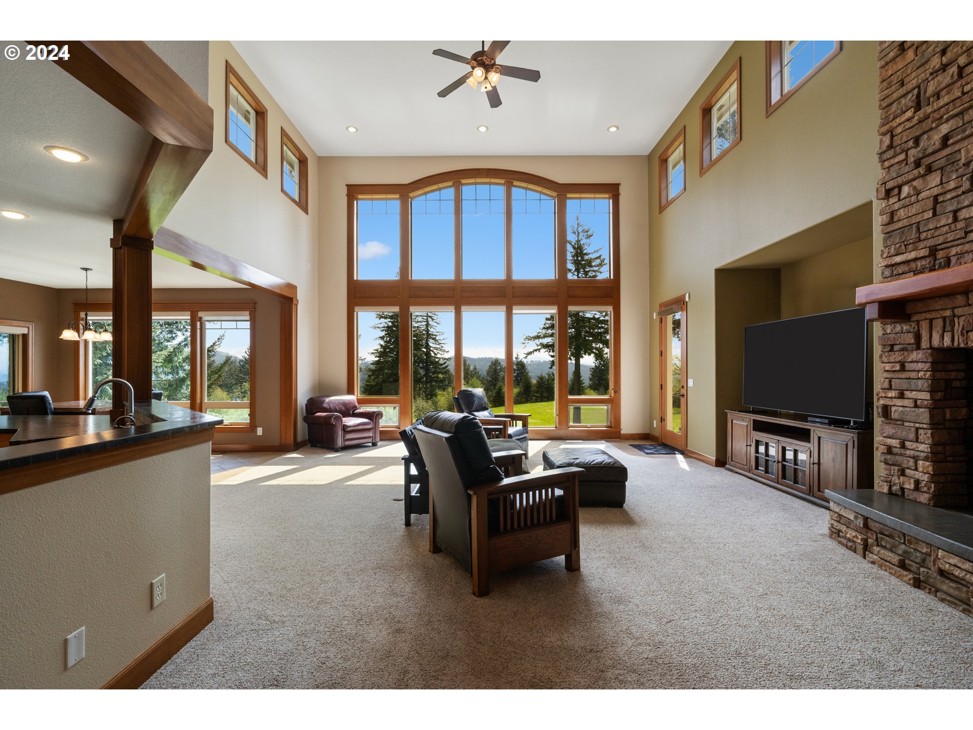 5924 Northeast Lessard Road Camas, WA 98607 - Photo 9 of 48 a living room with furniture a flat screen tv and floor to ceiling window