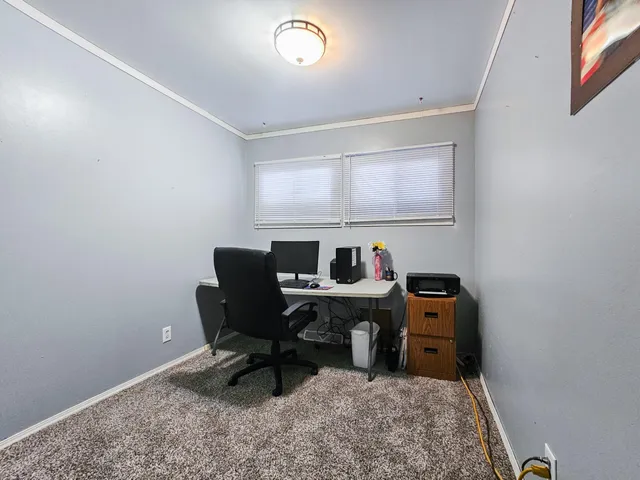 a view of a workspace with furniture