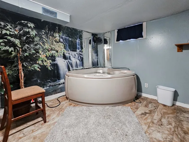 a white toilet sitting next to a bathroom sink and vanity
