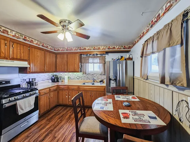 a kitchen with a sink a stove and chairs