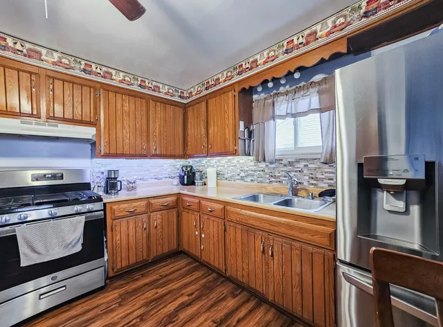 a kitchen with stainless steel appliances a stove sink and cabinets