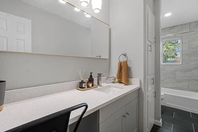a bathroom with a sink vanity and a mirror