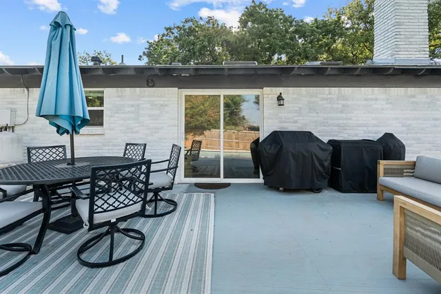 an outdoor living area with furniture and a fireplace