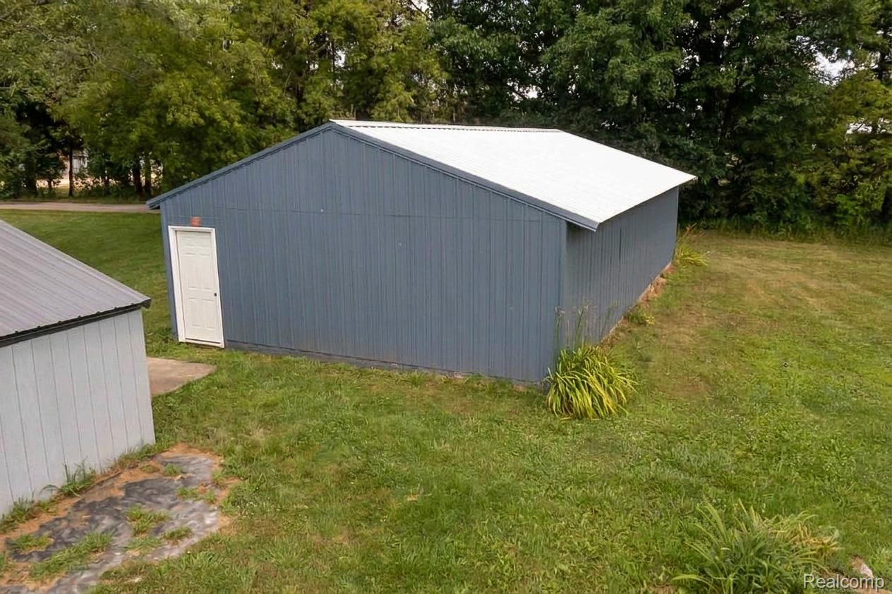 5761 Genesee Road Lapeer, MI 48446 - Photo 49 of 52 Large utility building with a light blue exterior siding and white metal roof