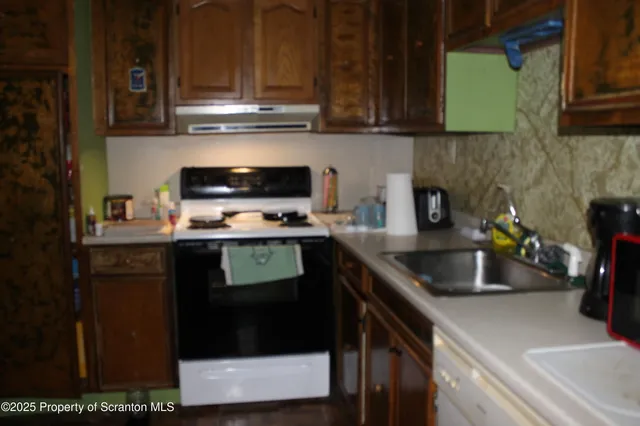 a kitchen with a sink a stove and cabinets