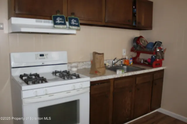 a kitchen with a stove and cabinets