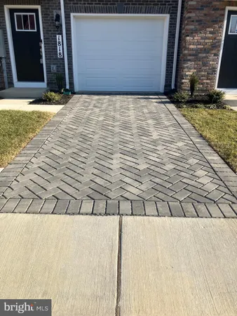 a close view of a sink a mirror and window in the room