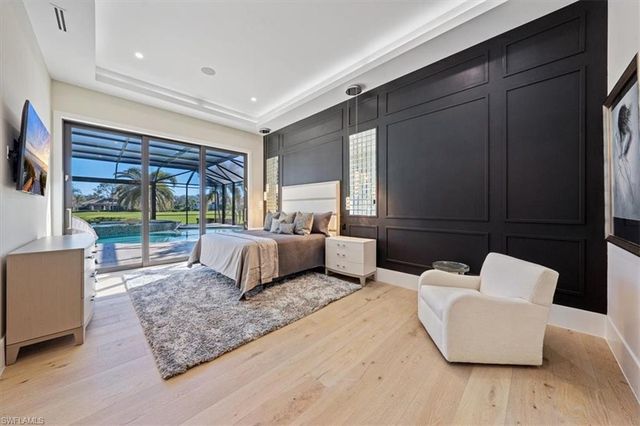 a bedroom with furniture and large window