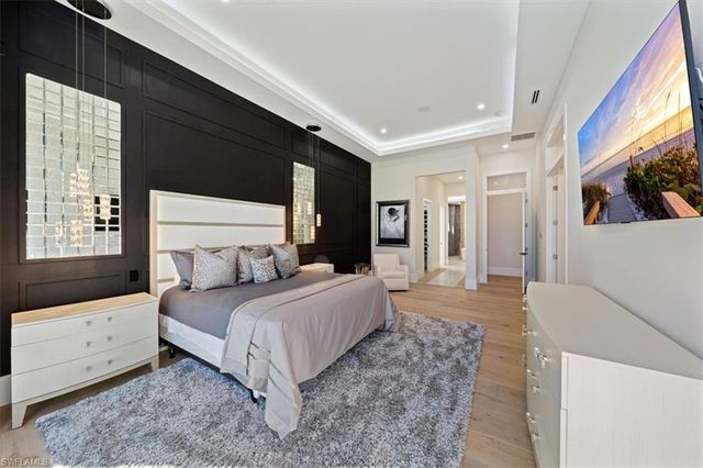 a bedroom with a large bed and a window