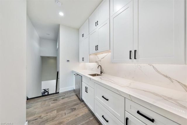 a spacious bathroom with a granite countertop sink and a mirror