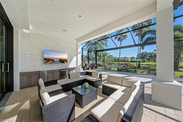 a living room with furniture a large window and a table
