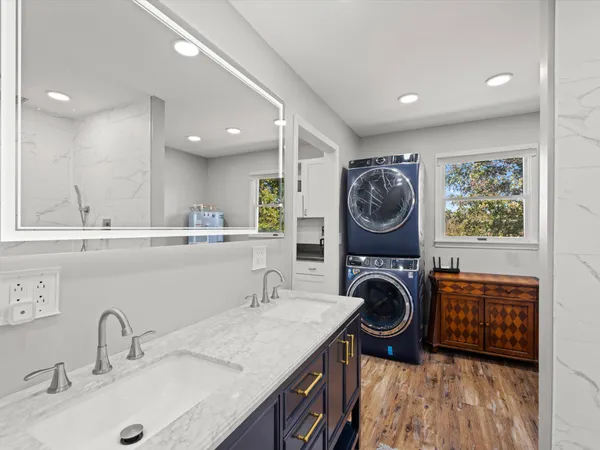 a view of a sink a washer and dryer