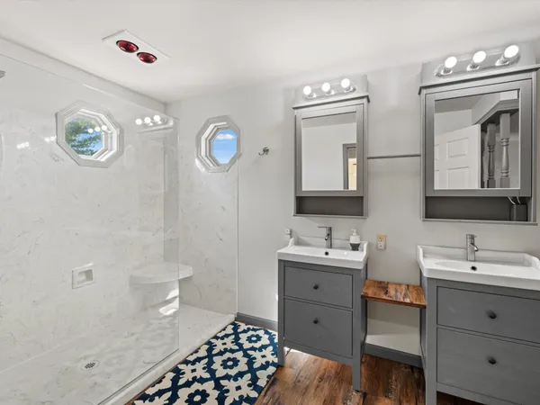 a bathroom with a sink a toilet and a mirror