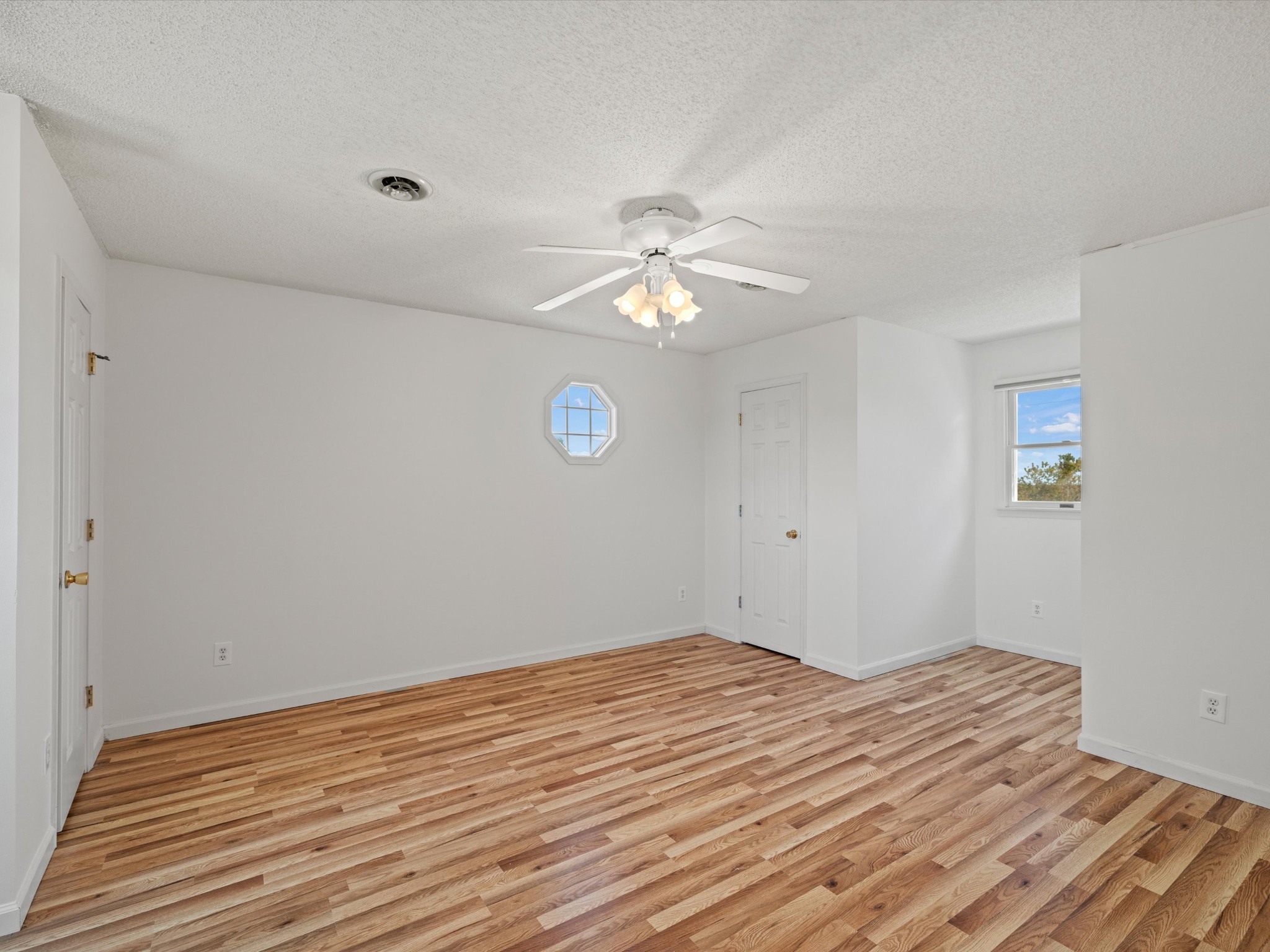 395 Carroll Gentry Road Madisonville, KY 42431 - Photo 28 of 46 a view of a room with wooden floor and a ceiling fan