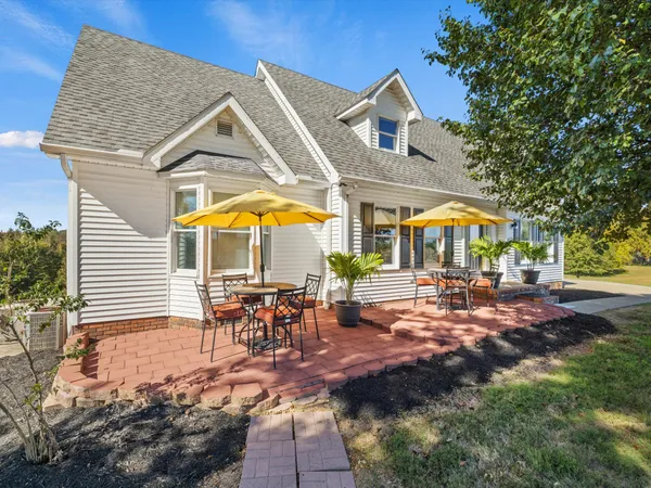 a view of a house with backyard porch and sitting area