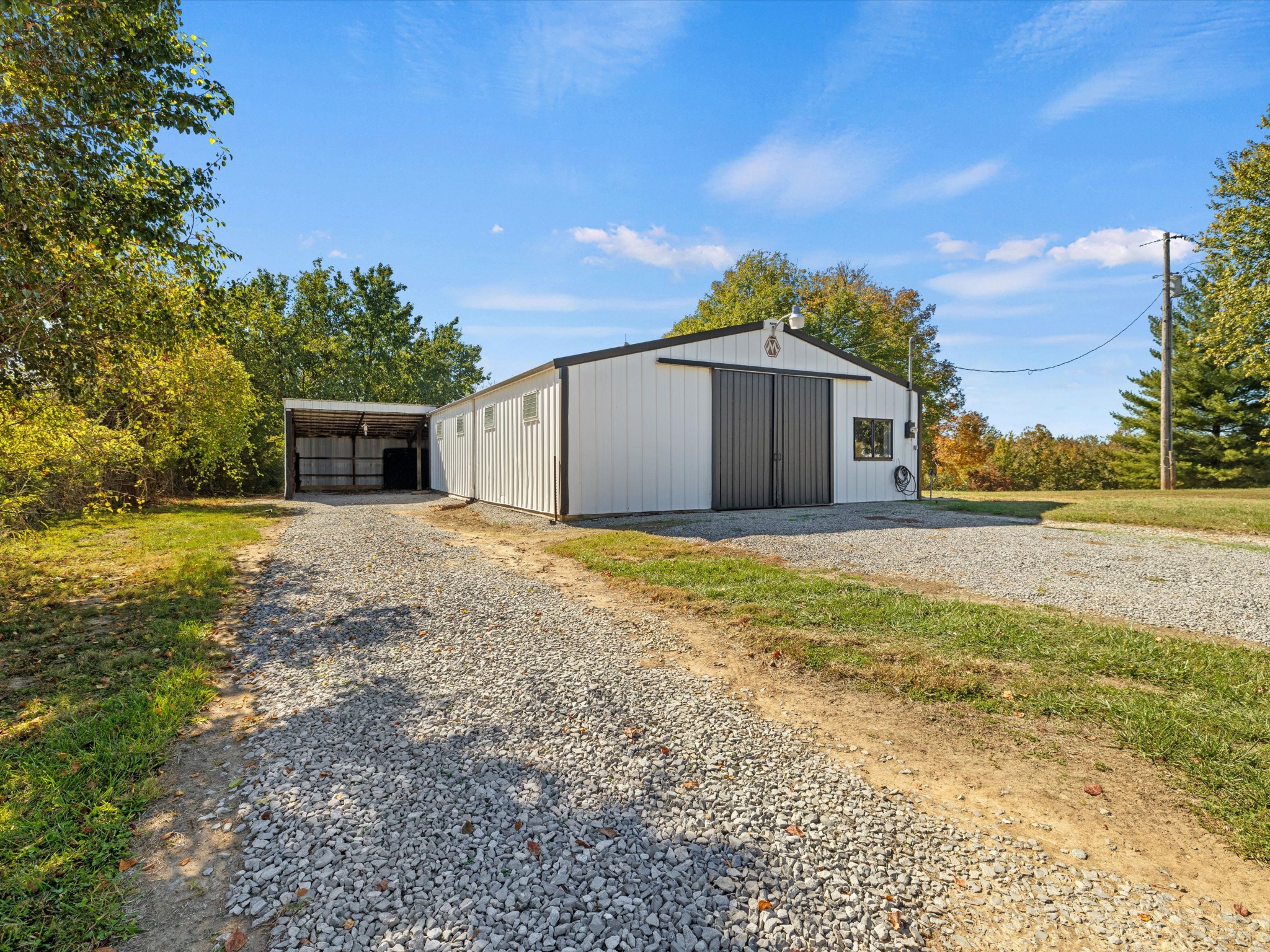 395 Carroll Gentry Road Madisonville, KY 42431 - Photo 36 of 46 a view of a house with backyard and trees