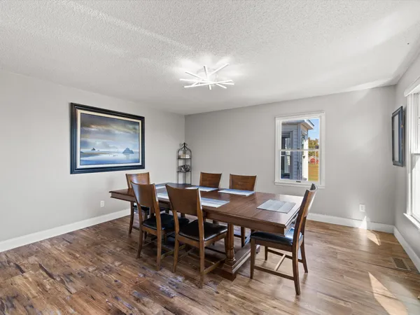 a view of a dining room with furniture and wooden floor