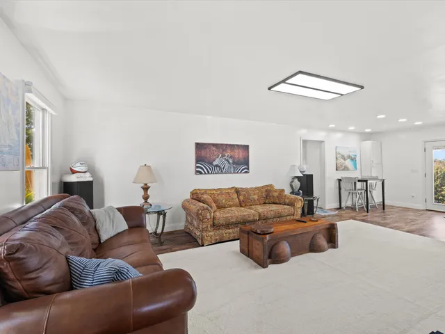 a living room with furniture and a ceiling fan