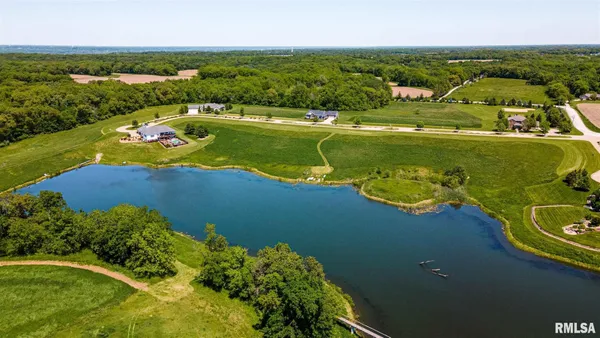 an aerial view of a houses with a lake view